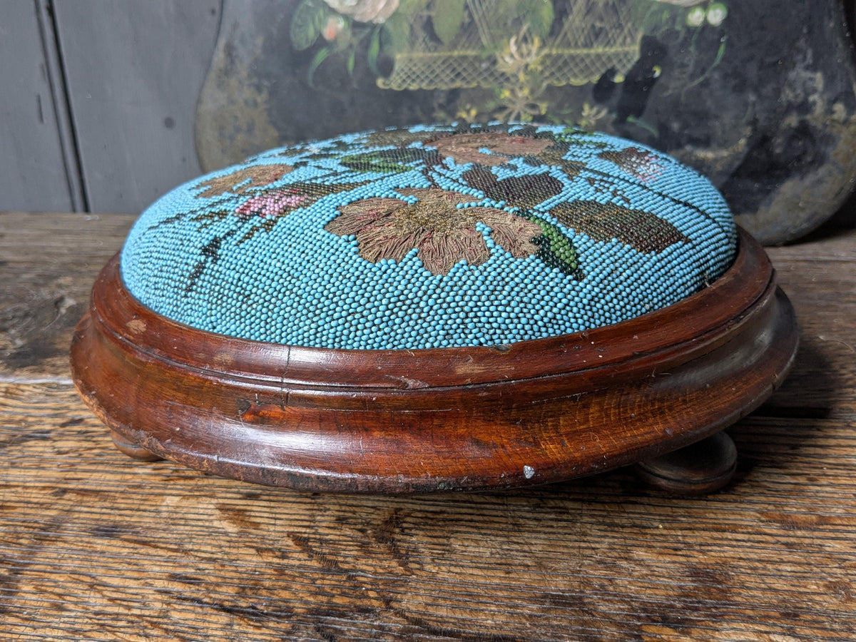 Antique footstool, beaded upholstered top