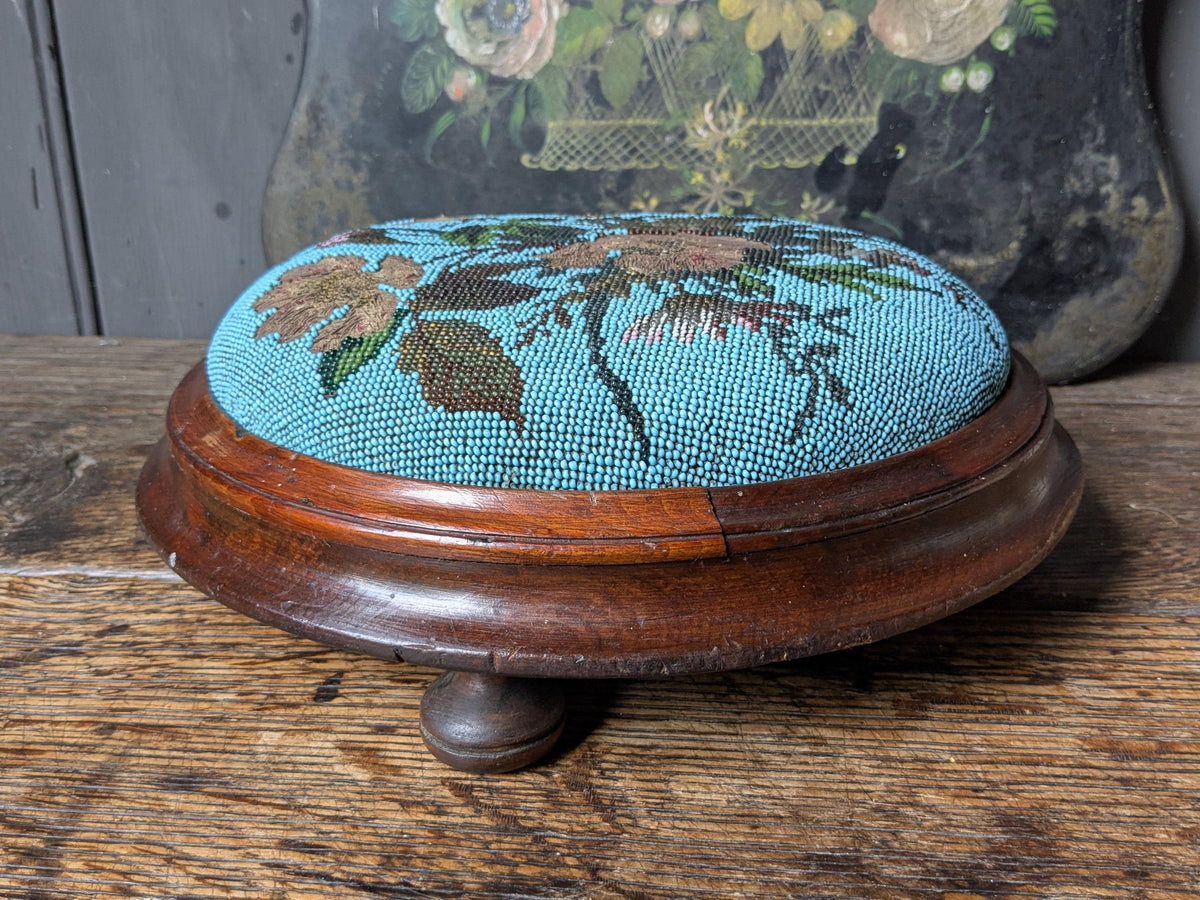 Antique footstool, beaded upholstered top