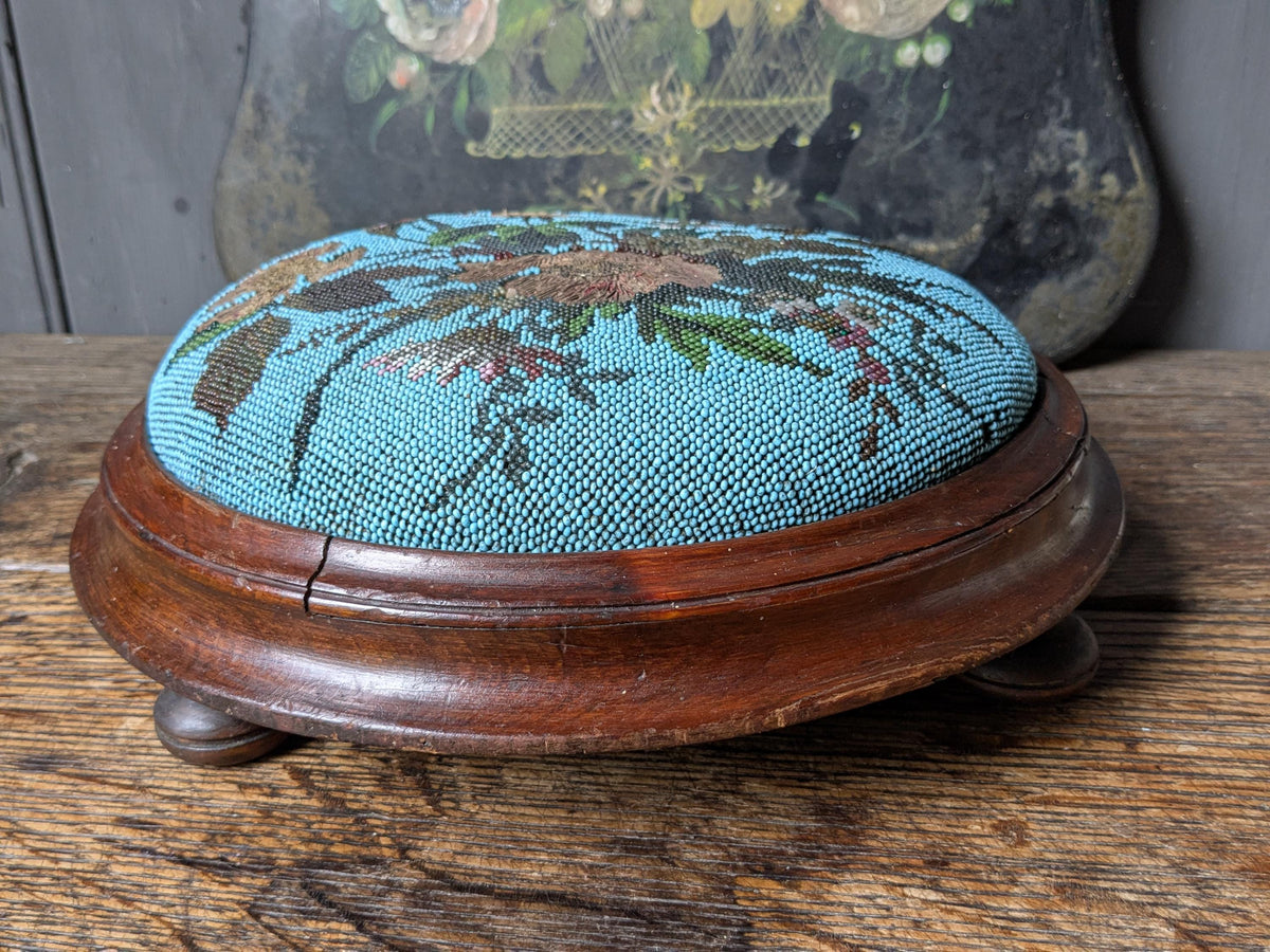 Antique footstool, beaded upholstered top